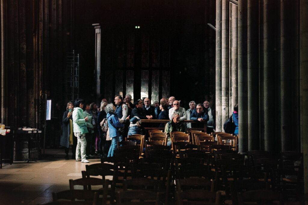 Group of visitors inside the historic Rouen Cathedral, Normandy, France.